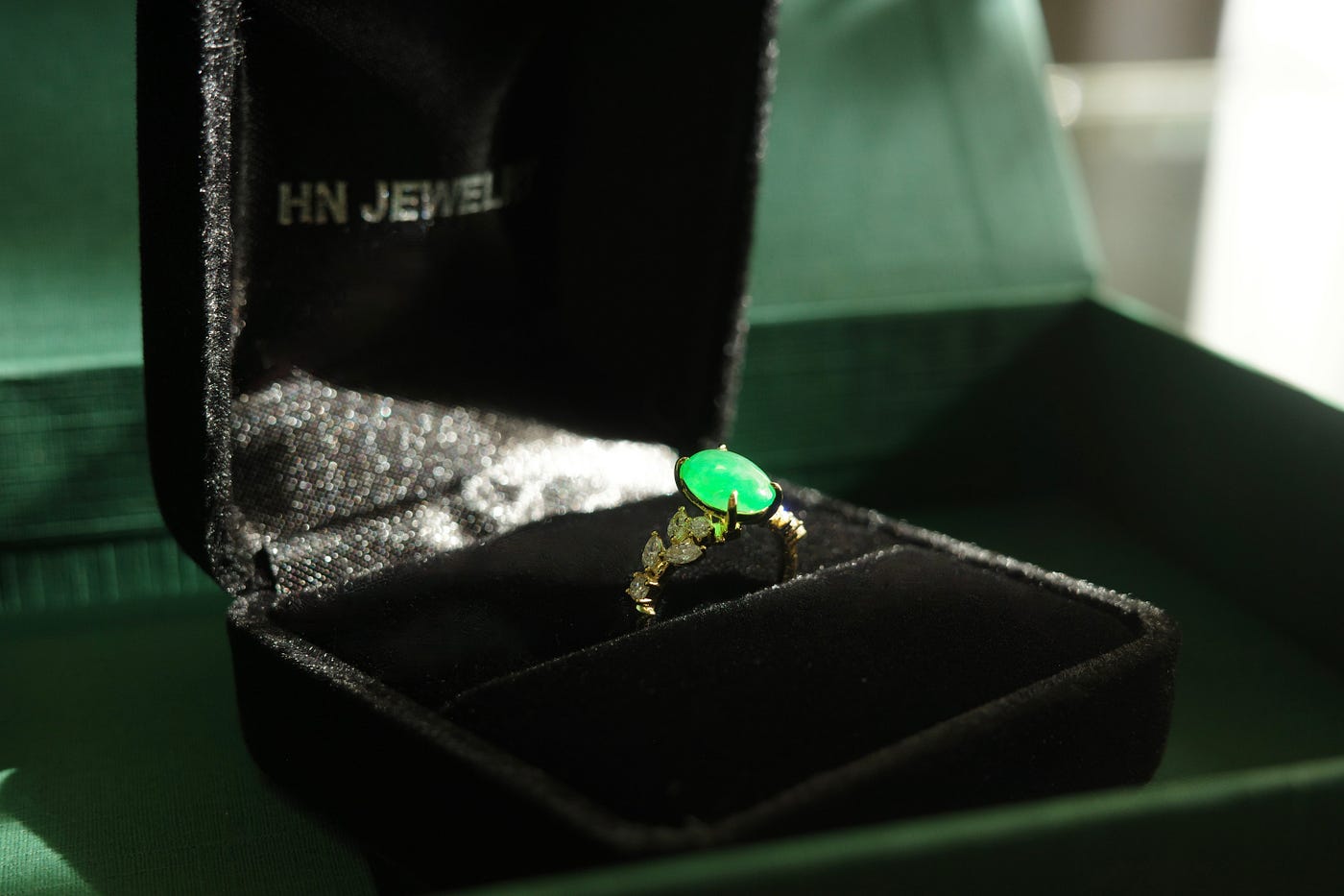 natural green oval jade sit on HN Jewelry brand jewelry ring box
