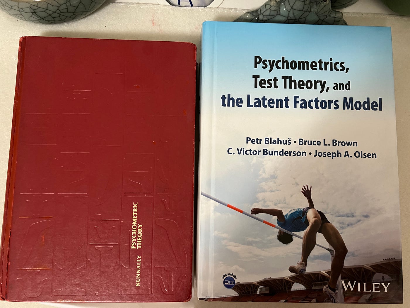 Classic psychometrics texts on my art desk: Nunnally (2nd ed., 1978) and recent Blahuš et al. (Wiley) — reminding us that reliability is necessary, but validity is what matters when building trustworthy LLM evals.
