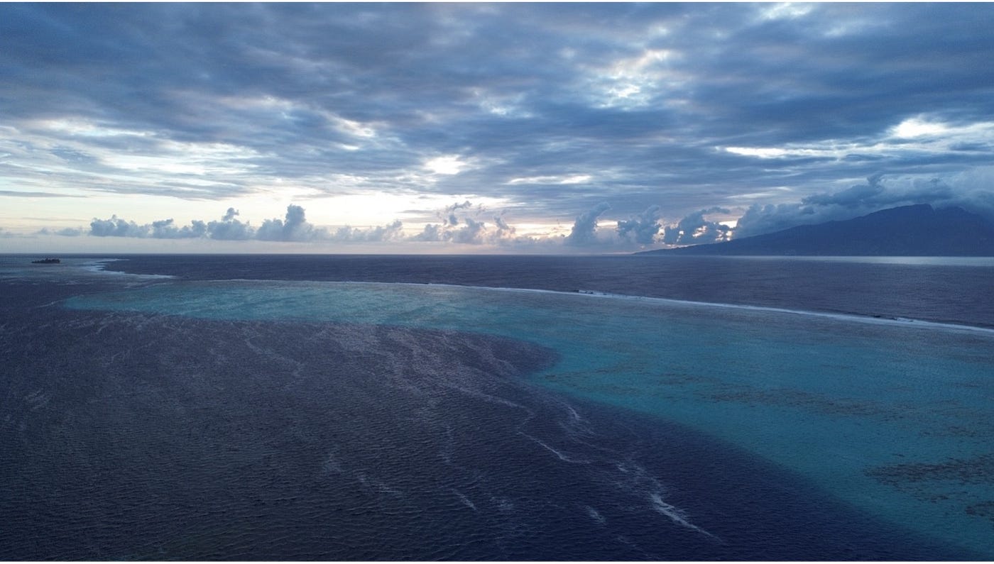 The slumbering behemoth Tahiti rises in the East amidst a vengeful ocean.
