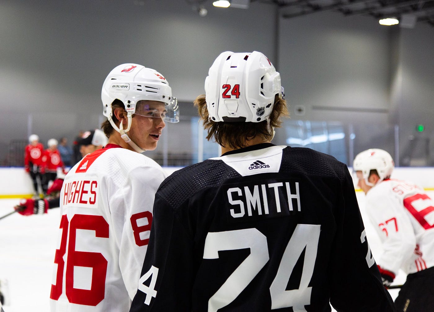 New Jersey Devils defenseman Ty Smith (24) skates with the puck