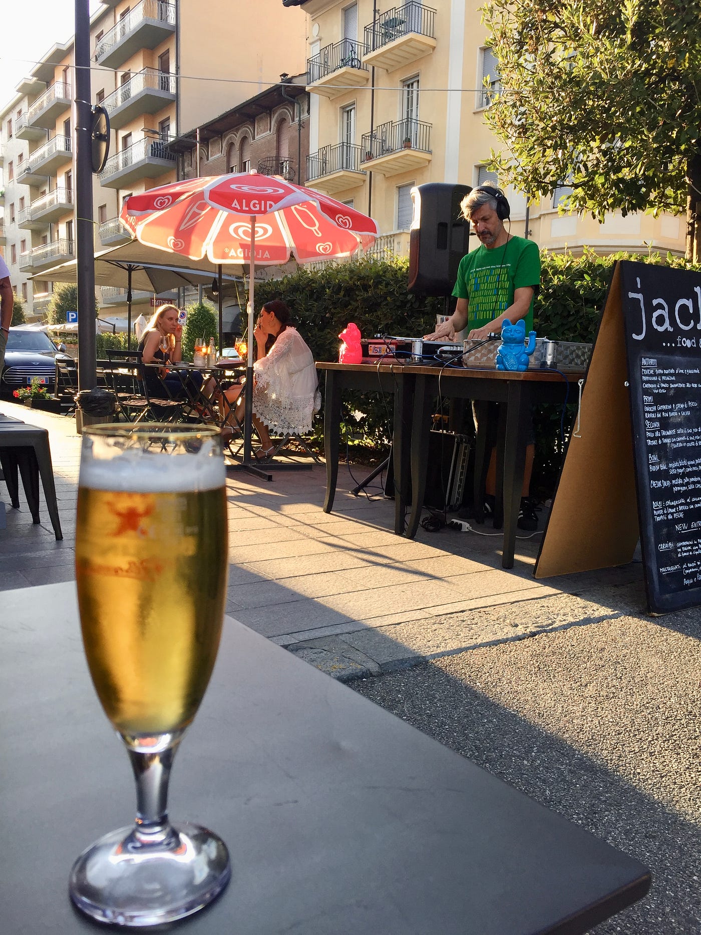 A beer on a table at Jack’s outdoor terrace with a DJ in the background