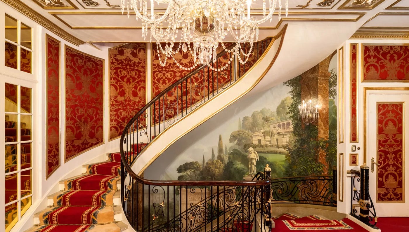 The actual stairs where Mrs. Trump was found dead. A steeper slope results in a greater component of gravitational force acting down the incline, leading to increased acceleration. A curved staircase, like this one, has a gentler slope compared to a straight staircase. The curvature also creates shorter segments of uncontrolled falling before each impact occurs, reducing the overall force of the fall by limiting the vertical distance over which a person can accelerate.