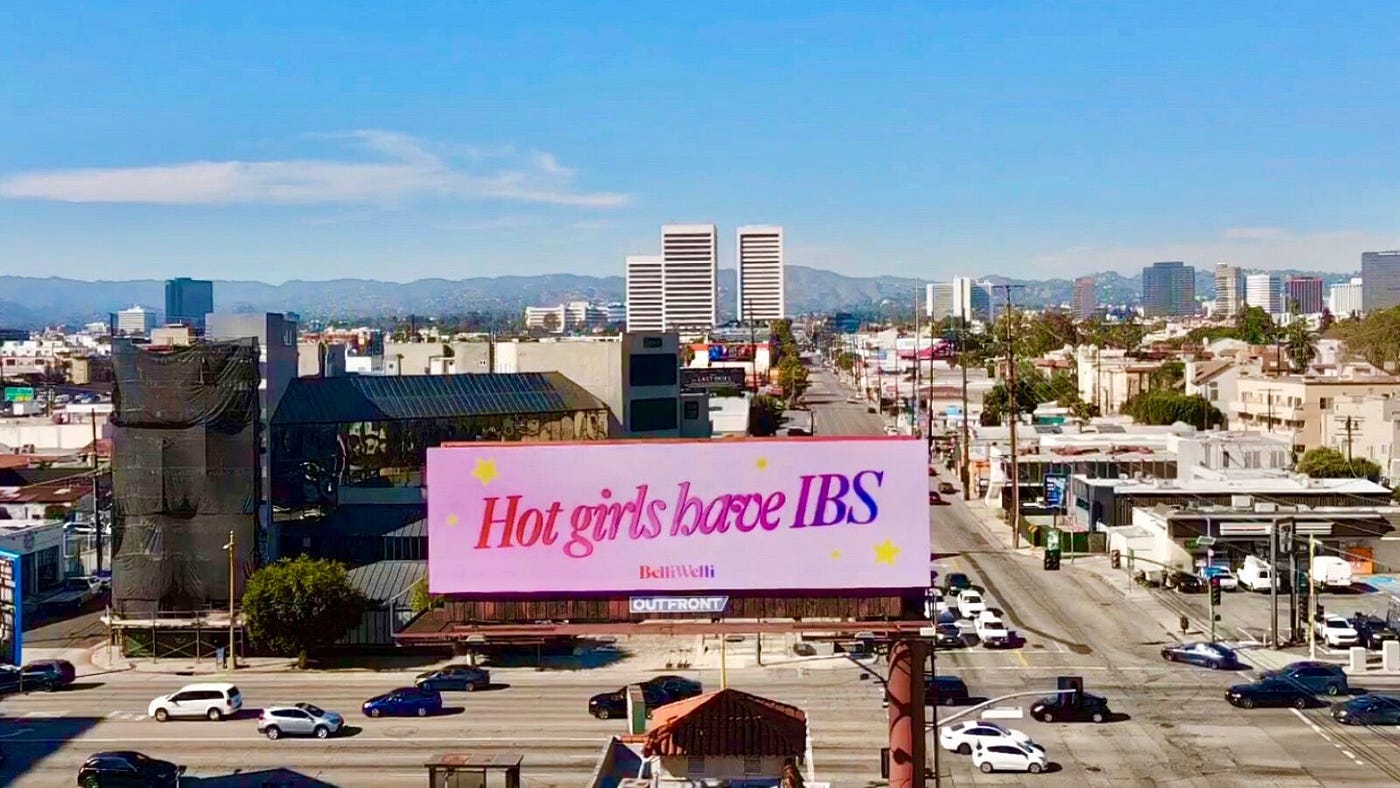 A BelliWelli billboard above traffic in Los Angeles declares, “Hot girls have IBS.” The billboards went viral in late 2021, and have been erected in three other cities. BELLIWELLI