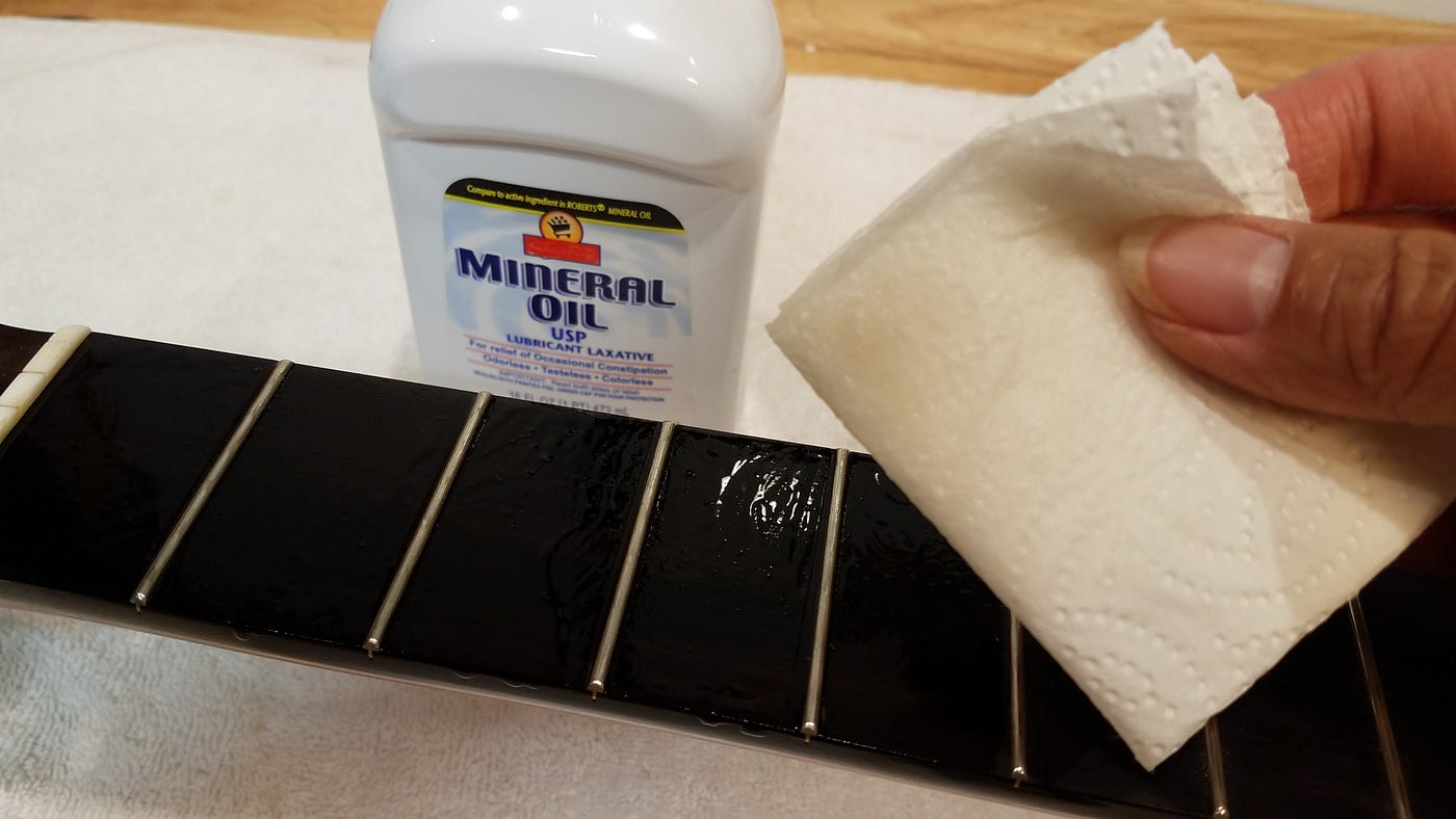 How long do I keep the oil when cleaning the fretboard.
