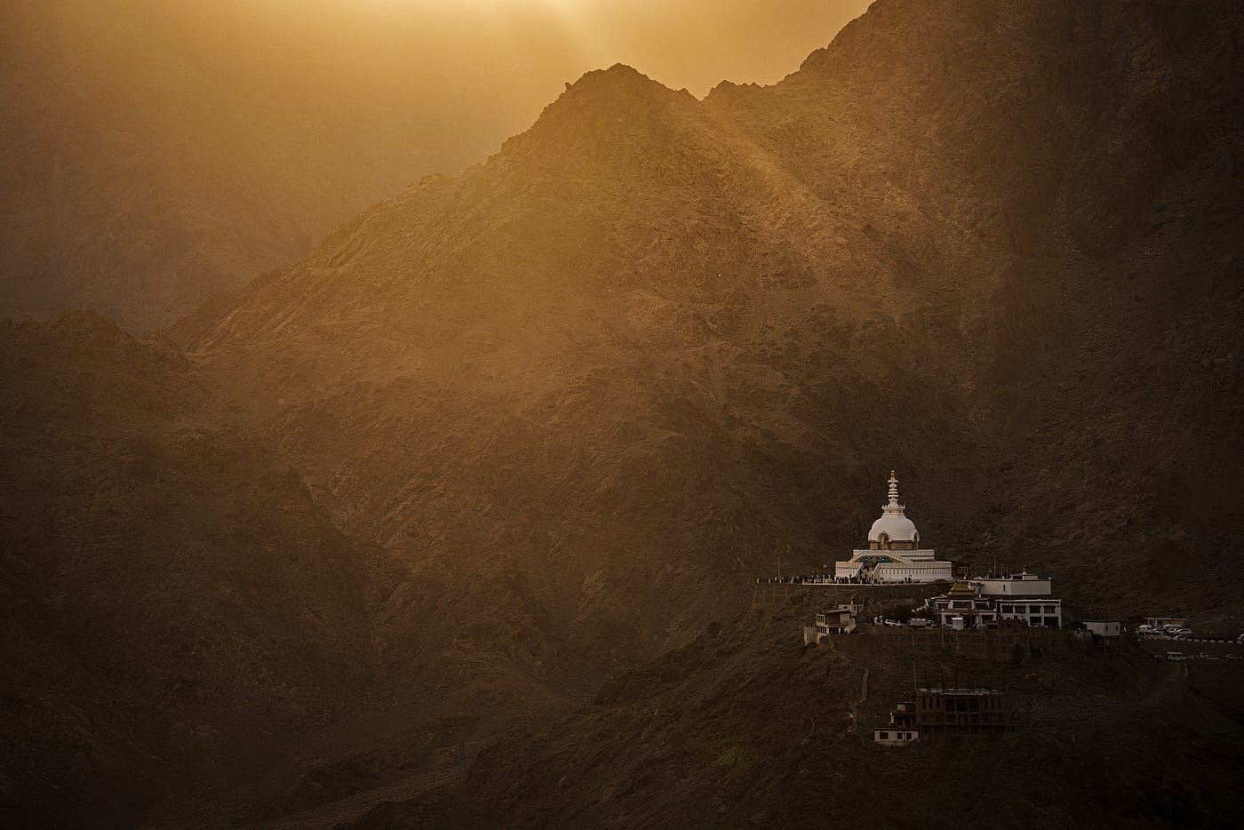 Where light meets the Himalayas, a monastery glows in quiet solitude — photographed by Arun Saha Photography.