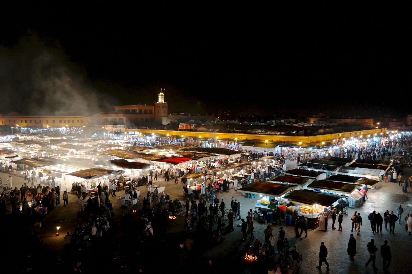 Marrakech or Fes - Jemaa el-Fna square at night with lanterns and crowds