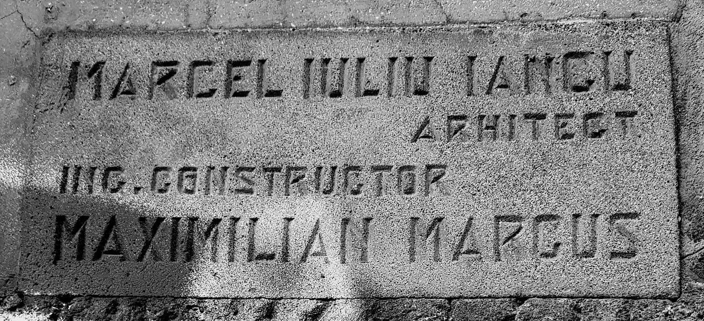 This plaque on the exterior wall of the Solly Gold building should read Marcel si Iuliu Iancu