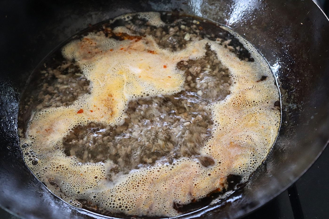 As the broth simmers, the pork, garlic, and ginger gradually release their flavor.