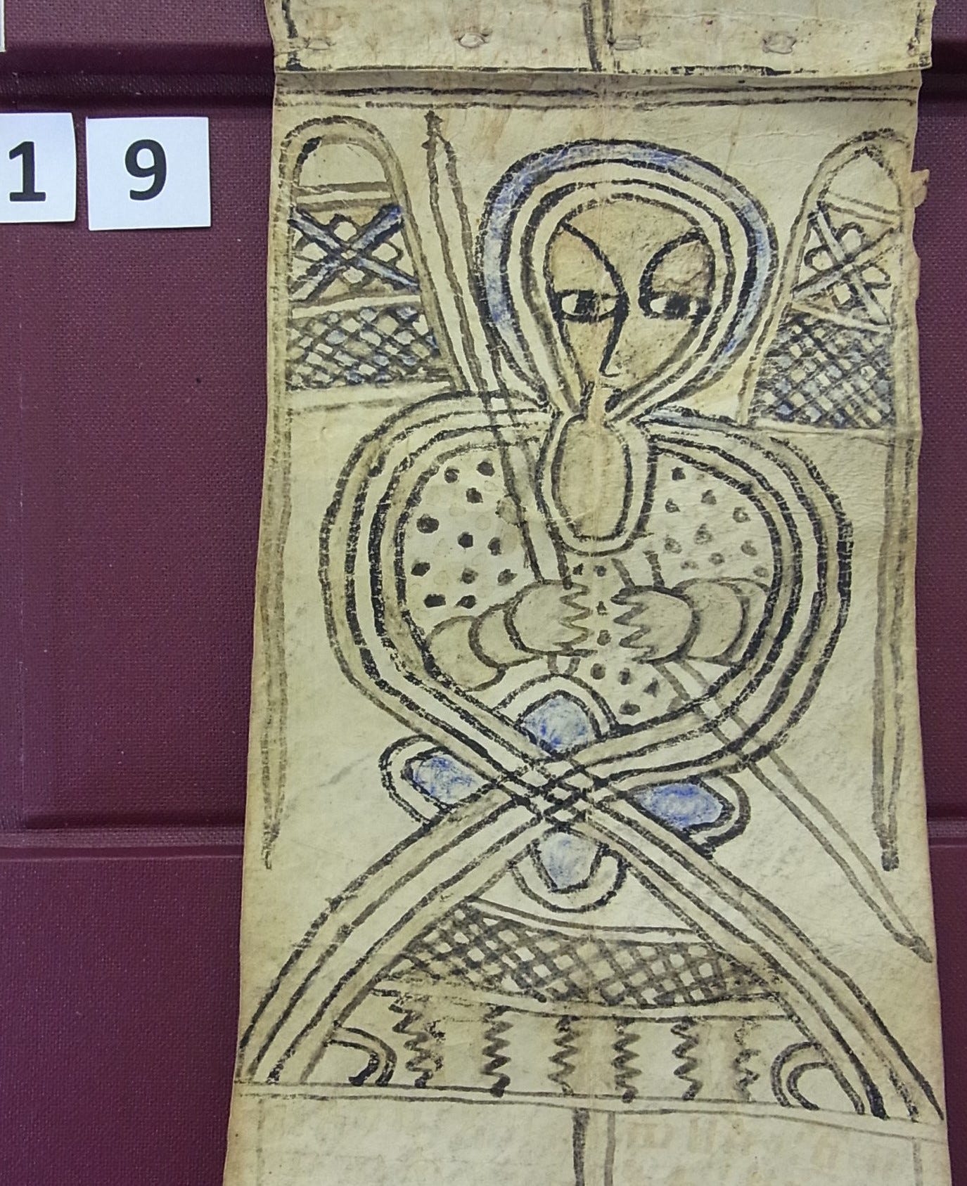 Photograph of a section of a narrow scroll with an illustration of an angel with a sword from Wellcome MS 19