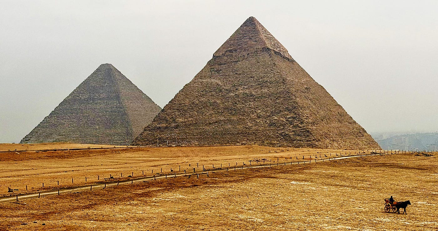The Great Pyramid of Khufu on the left was the first and largest. The Pyramid of Khafre retains some of its original outer casing near the peak. Photo: David A. Laws