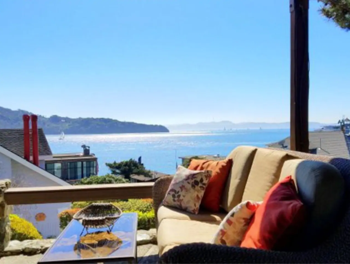 View of the Bay from a patio with an outdoor couch on it.