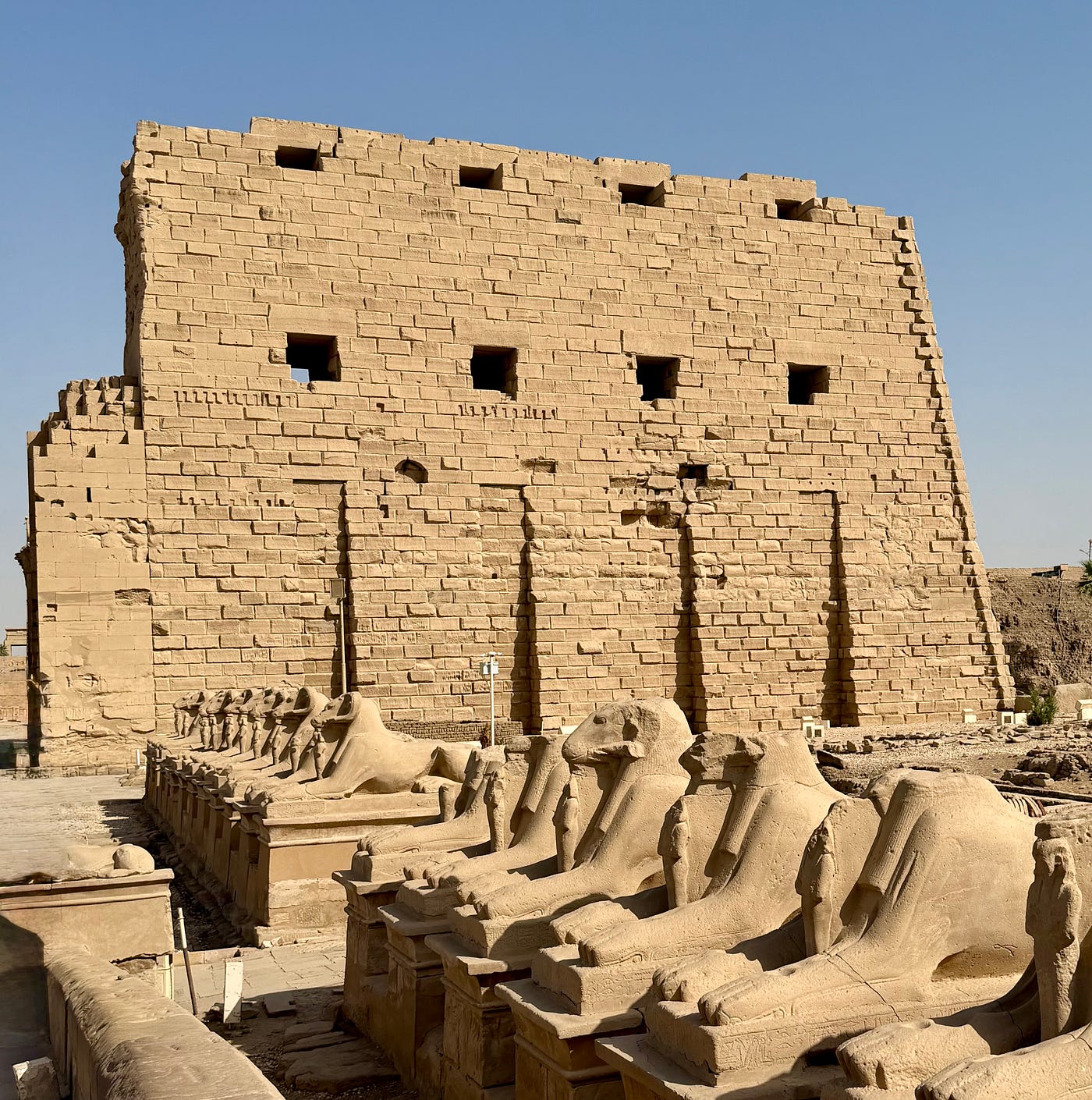 Rams head sphinxes line the approach to the twin pylon towers of Karnak. Photo: David A. Laws