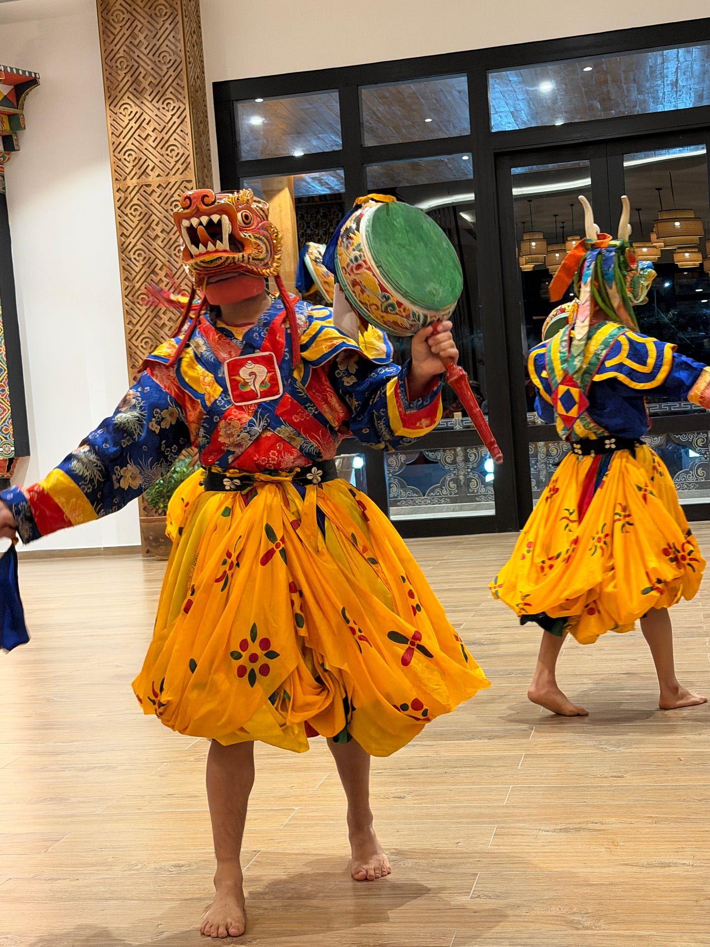 Traditional dancers in spectacular costumes — vivid silk robes, enormous painted masks representing deities and demons and elaborate headdresses. Photo: Marybeth Bond