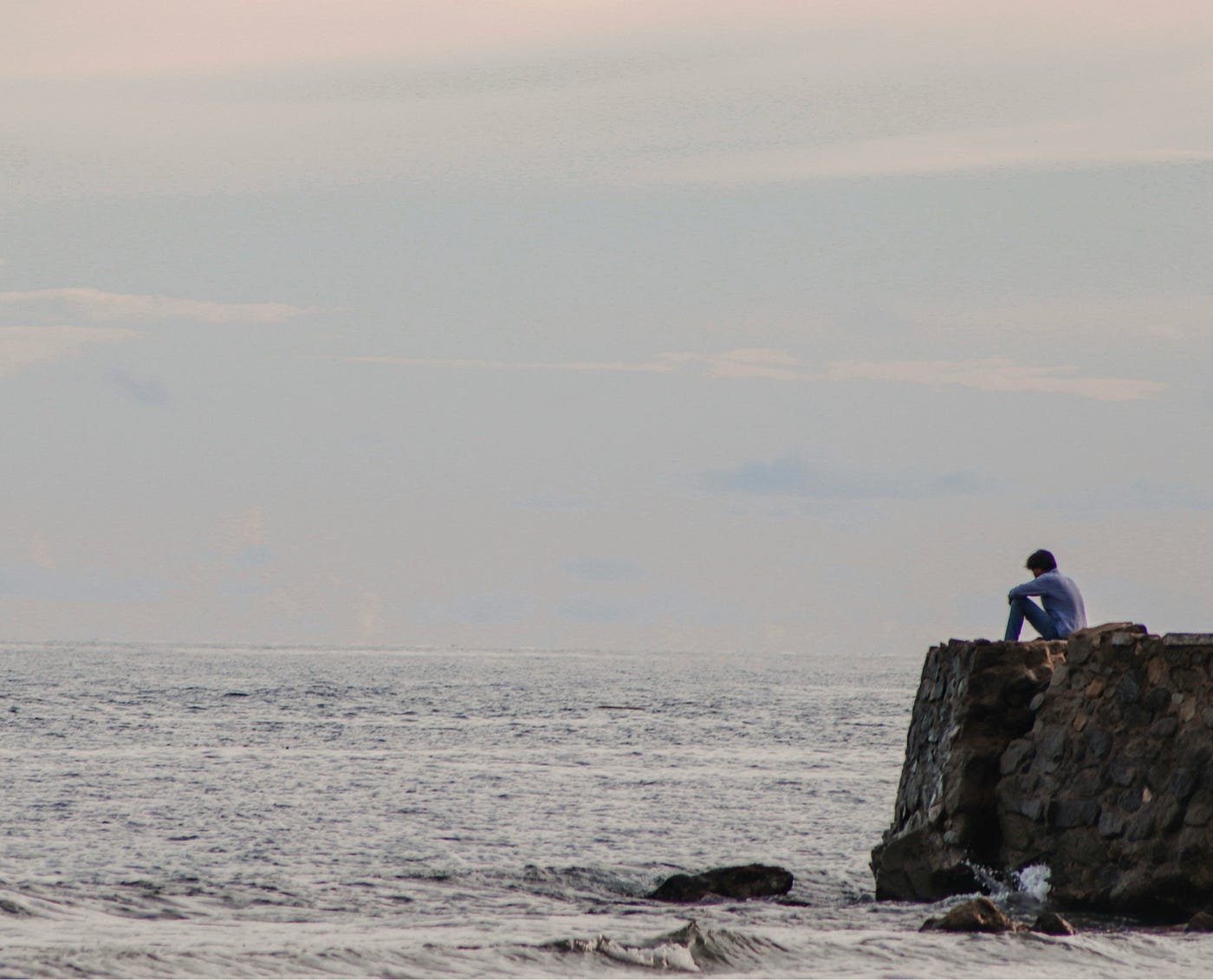 Sitting by the sea by Andika Christian on Unsplash