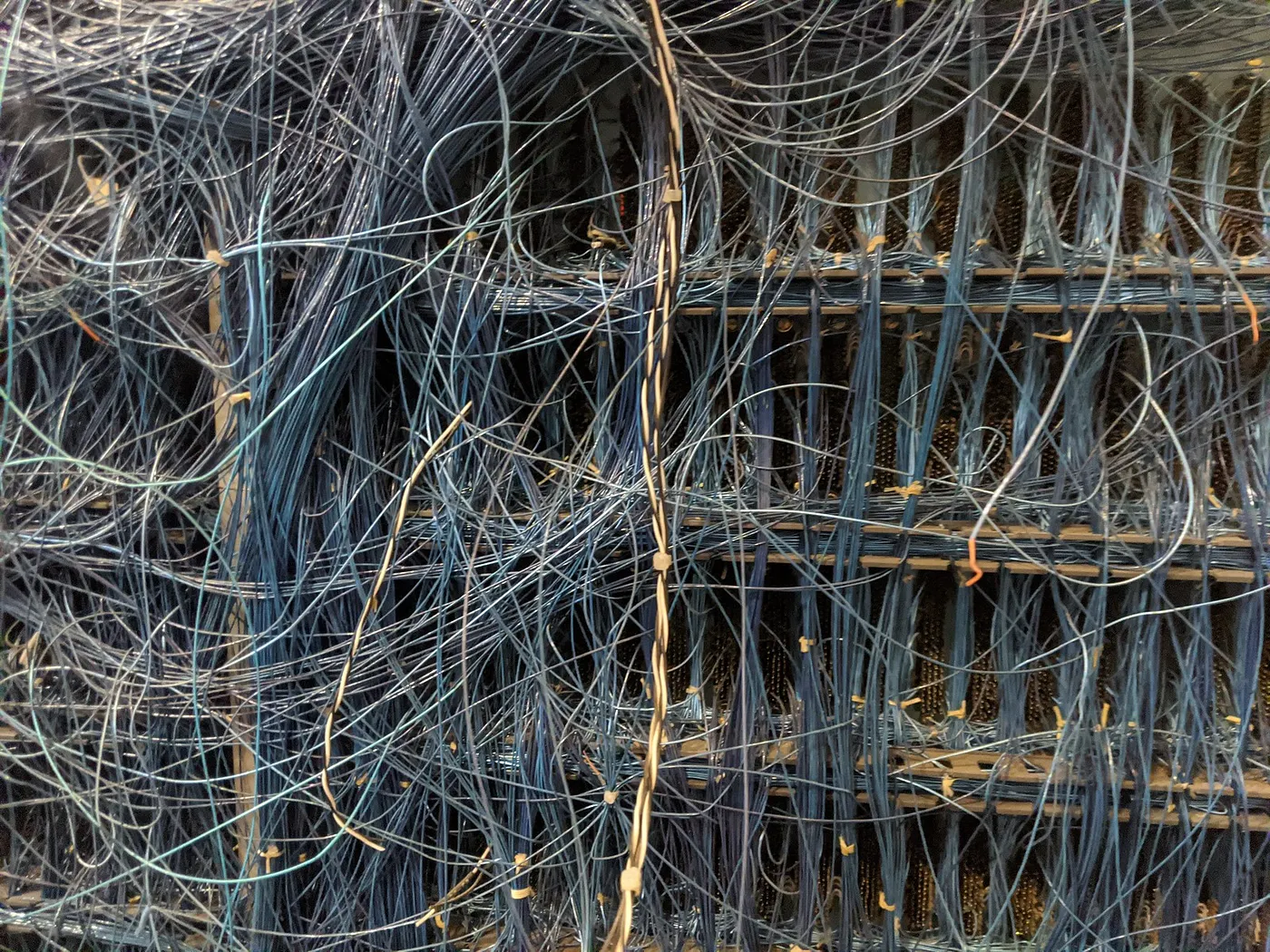 The complex, hand-wired backplane of an electromechanical supercomputer at the Computer History Museum boneyard; it is an impossible tangle of wires joining various subassemblies.