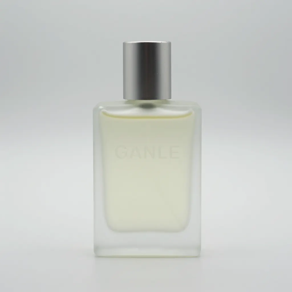 Studio-grade product shot of a fragrance bottle with frosted glass, embossed logo text visible, subtle imperfections on metal cap, softbox reflections, neutral white background, ad-campaign realism.