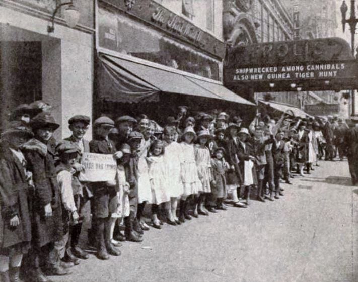 Vintage photo of a long line of people outside the Frolic Theater.