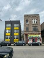 New construction sits besides long standing family businesses, highlighting the clash between preservation and development in Pilsen (photo/Royrie Curry).