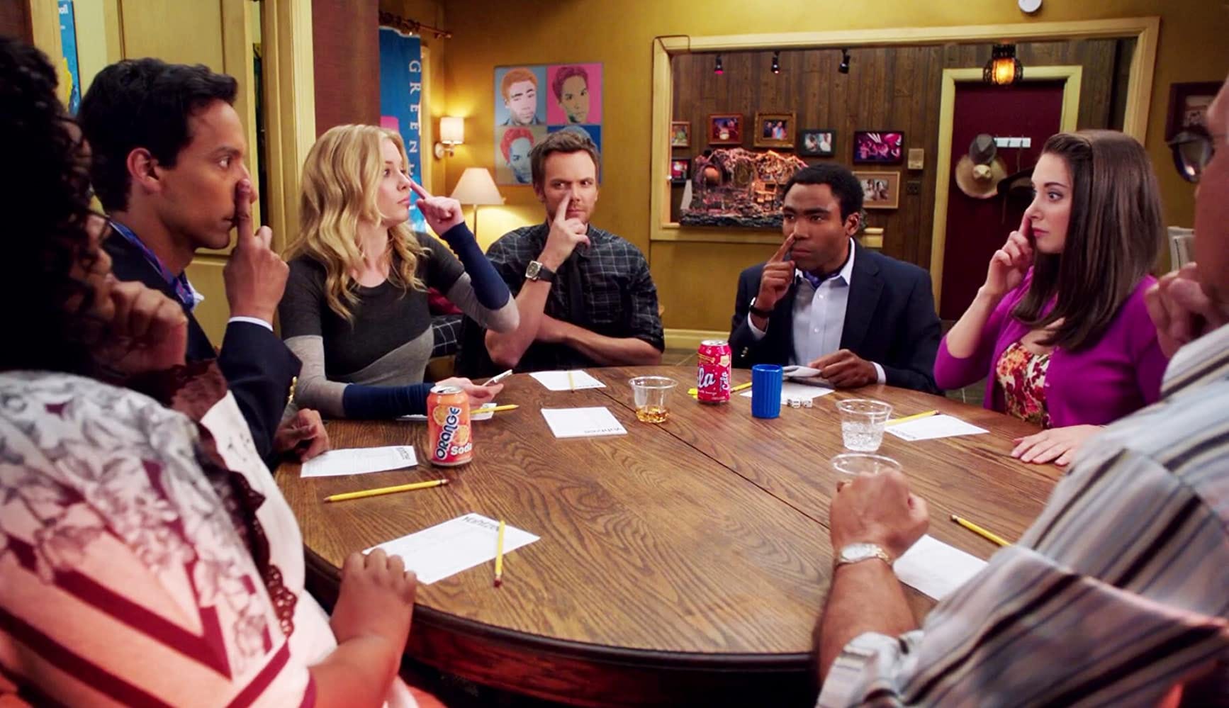 Community. 2009-2015. NBC. The study group sitting around a table playing nose goes. 