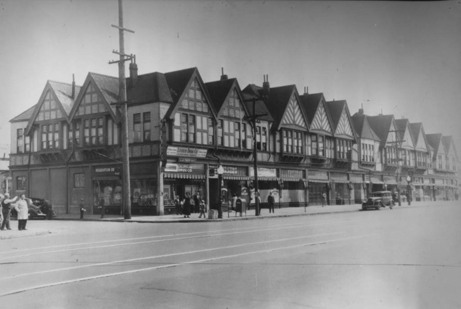 Black-and-white photo of a block of shops.