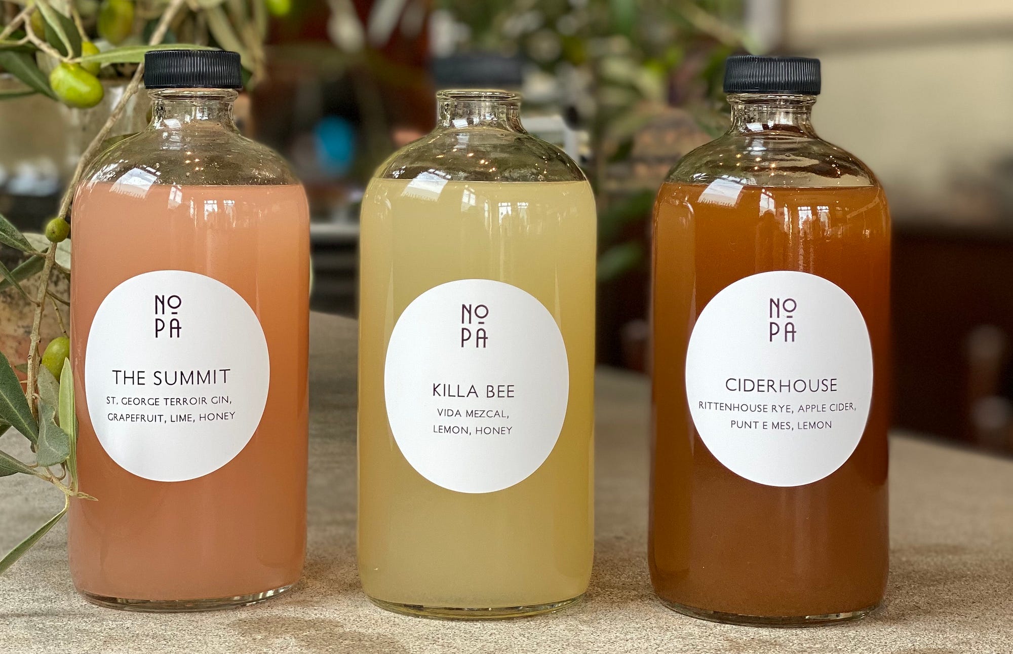 3 bottles of Nopa’s drink mixes: The Summit, Killa Bee, Cider House.