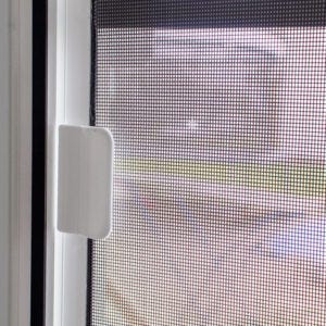 Modern aluminum screen door on a coastal home
