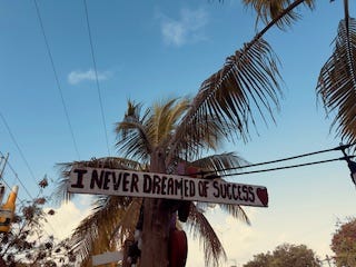 A handmade sign on a street corner south of Tulum Town.