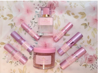 Pink and purple beauty products laid out on a floral background.