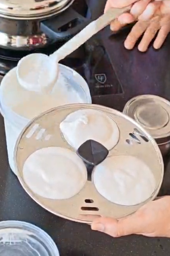 Batter is added to metal pans designed for making idli (Photo credit: Cuifen Pui)