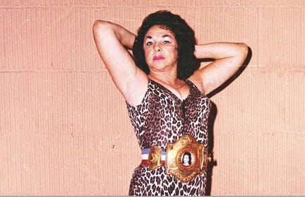 The Fabulous Moolah and her Championship Belt, emblazoned with her face, in the early 80s. Courtesy of World Wrestling Entertainment.