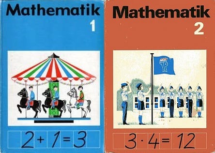 Covers of grade 1 and 2 math textbooks from the former GDR which include pictures of a carousel and of a roll call.