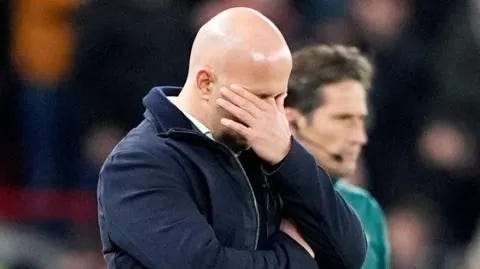Arne Slot holds his hand over his face, no doubt wondering where it all went wrong