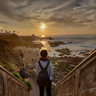 Women looking at a beach at sunset.