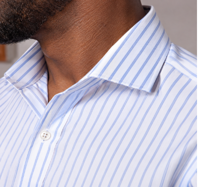 Close-up of a crisp striped dress shirt collar supported with collar stays