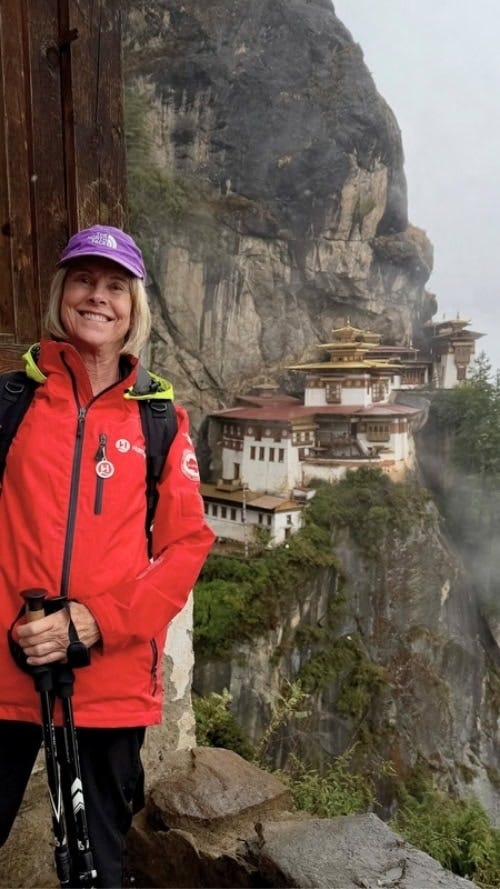The author on the hike to the legendary Tiger’s Nest, known formally as Taktsang Monastery, dramatically perched on a vertical cliff face at 10,121 feet. Credit: Marybeth Bond