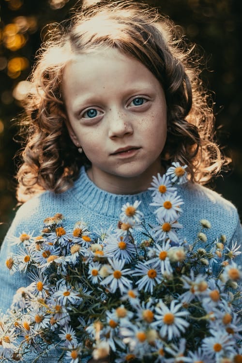 little girl holding flowers