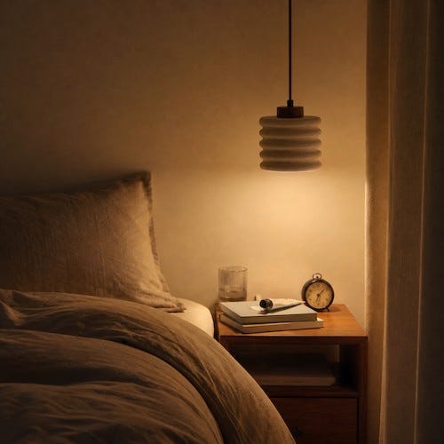 A Small Travertine Pendant for a Quieter Bedside