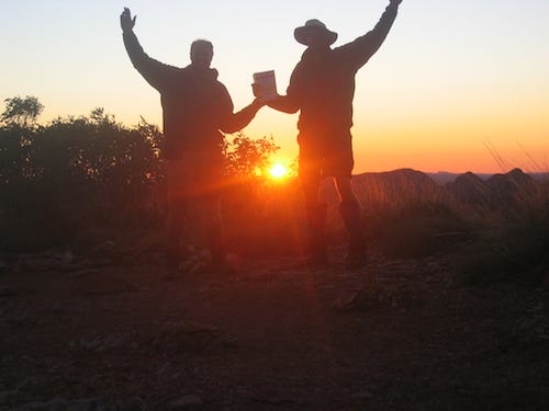 My friend Anthony and I with our copy of ‘FREEDOM’, with a spectacular sunrise on Mt Sonder during our hike on the Larapinta Trail.