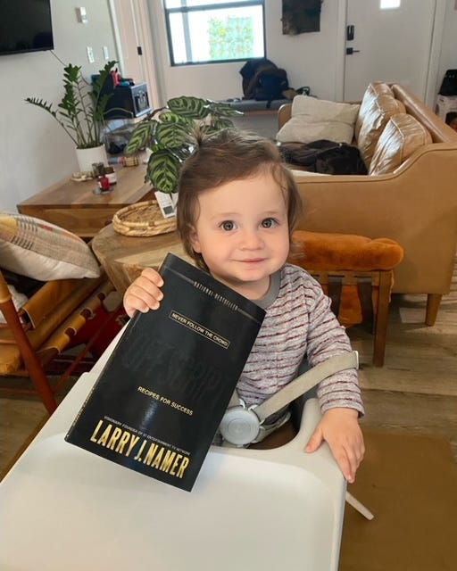 Larry Namer’s grandson with the book