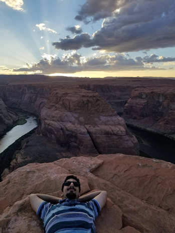 Man laying down under the sunset.