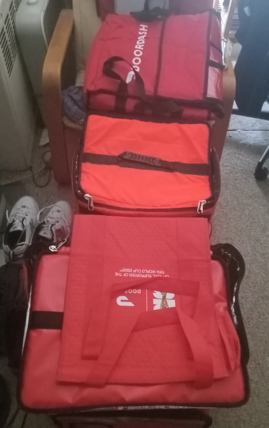 photo by author (Who needs a free DoorDash bag? What am I gonna do with all these?)