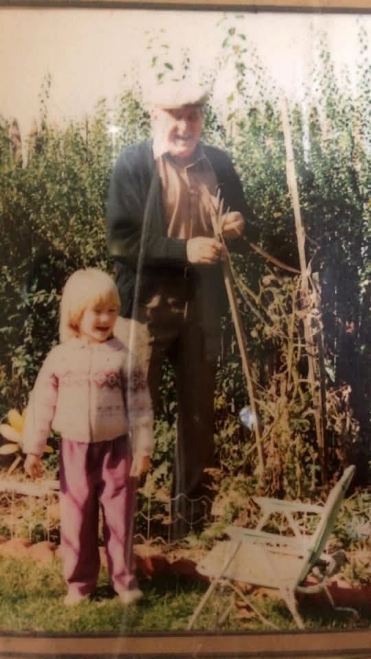 Author’s pic of my dad & my first-born in the garden tying up tomato plants