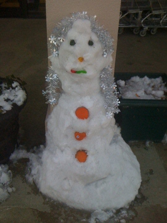 Snowman outside Wholesome Shopper Market
