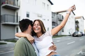 Young couple touring a home or receiving keys.