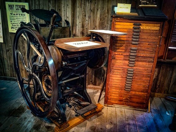 Picture of vintage printing press to represent changes that took place to represent when were jigsaw puzzles invented.