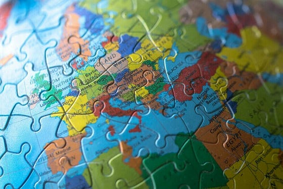 Picture of world globe in puzzle pieces to demonstrate when were jigsaw puzzles invented.