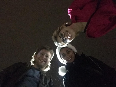 People posing outside at night.