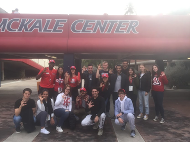 Group photo outside of a sports stadium.