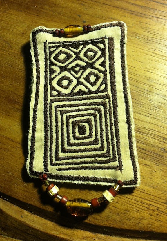 Left: My digitally embroidered Adinkra symbol; Right: One of Susan’s embroidered pins