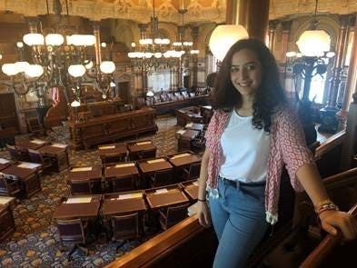 Woman posing in a library.